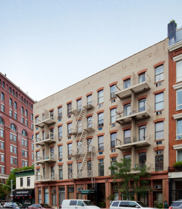 a large brick building with a fire escape on the side
